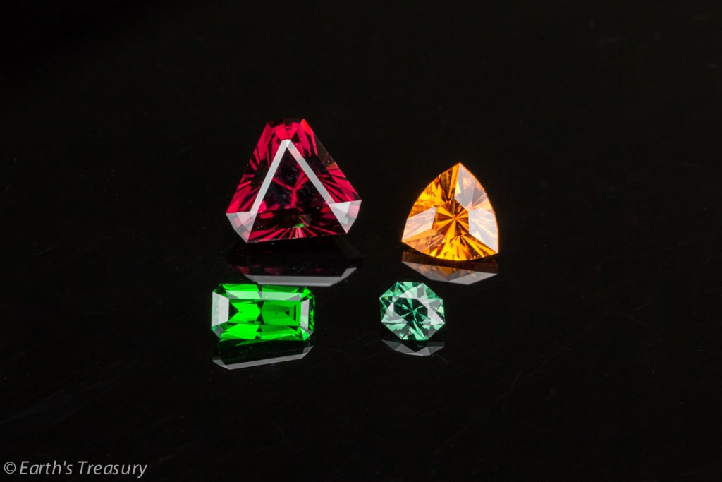 From left to right, back row first: Red rhodolite garnet from Kenya, cut in Marco Voltolini's "Tribal" design, 3.34 carats, 8mm; orange spessartite garnet from the Little Three Mine in California, 1.34 carats, 7mm Front Row, left to right: Tsavorite garnet from Kenya, 0.82 carats; unusual blue-green color-change garnet from a new find in Kenya, 0.27 carats.