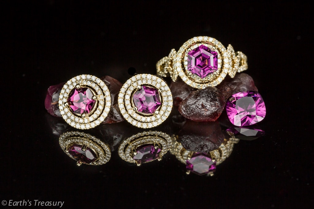 This photo shows rough rhodolite garnet nodules, a faceted "Umbalite" type rhodolite and rhodolite earrings and ring in a matching set.