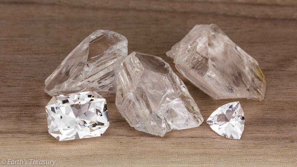 Danburite crystals from Mexico with two cut stones from the same lot of rough.  The left gem is a 10.17-carat rectangle, and the right a 2.15-carat trillion.