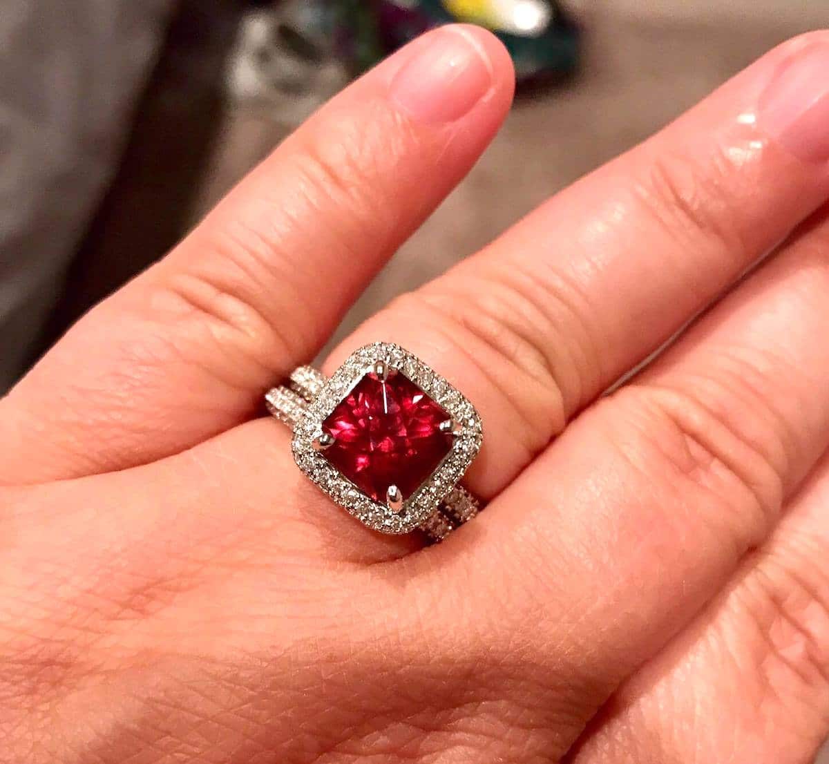 A photo from a customer review featuring a garnet set in a ring not made by Earth's Treasury