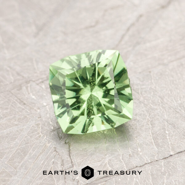 0.94-Carat Mint Green Grossular Garnet Introducing ET1108: A stunning square-cut green gemstone with precise facets, elegantly displayed on a textured gray surface.