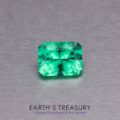 A 1.48-carat Ethiopian emerald, featuring a rectangular emerald cut, is displayed on a metallic gray surface. Below the gem, the text reads "Earth's Treasury: Custom Gemstones & Fine Jewelry.