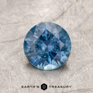 A blue Montana sapphire in a classic diamond round brilliant design