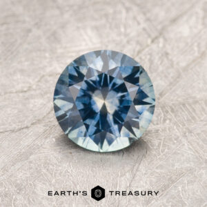 A particolored Montana sapphire in a classic diamond round brilliant design