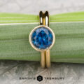 The “Luella” in 18k yellow gold with 2.06-Carat Montana Sapphire alongside the The Custom-Fit Straight Band in 18k yellow gold