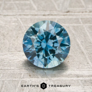 A particolored Montana sapphire in a classic diamond round brilliant design