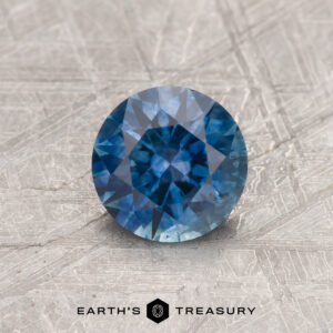 A blue Montana sapphire in a classic diamond round brilliant design