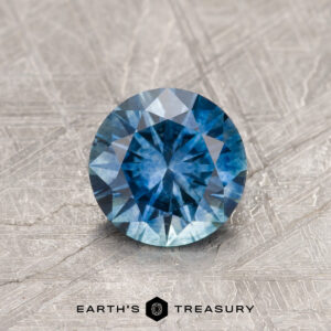 A blue Montana sapphire in a classic diamond round brilliant design