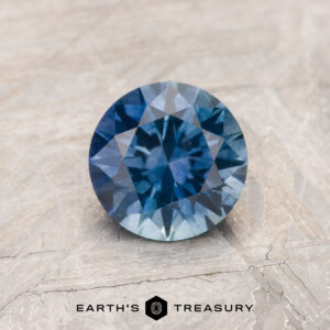 A blue Montana sapphire in a classic diamond round brilliant design