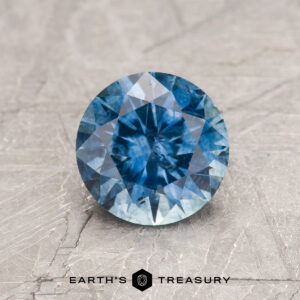 A blue Montana sapphire in a classic diamond round brilliant design