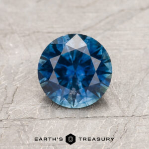 A blue Montana sapphire in a classic diamond round brilliant design