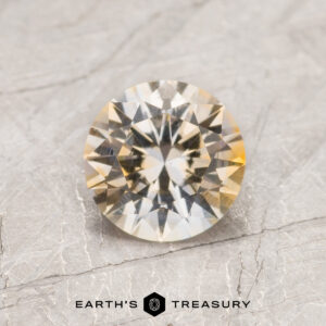 A particolored Montana sapphire in a classic diamond round brilliant design