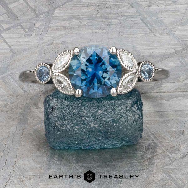 The "Calypso" ring in platinum with 2.10-carat Montana sapphire The "Calypso" ring in platinum features a 2.10-carat Montana sapphire as its centerpiece, flanked by two smaller gems and marquise-shaped accents—an elegant statement piece inspired by ocean hues.