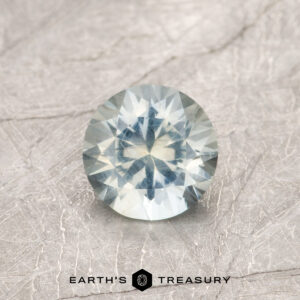 A particolored Montana sapphire in a classic diamond round brilliant design