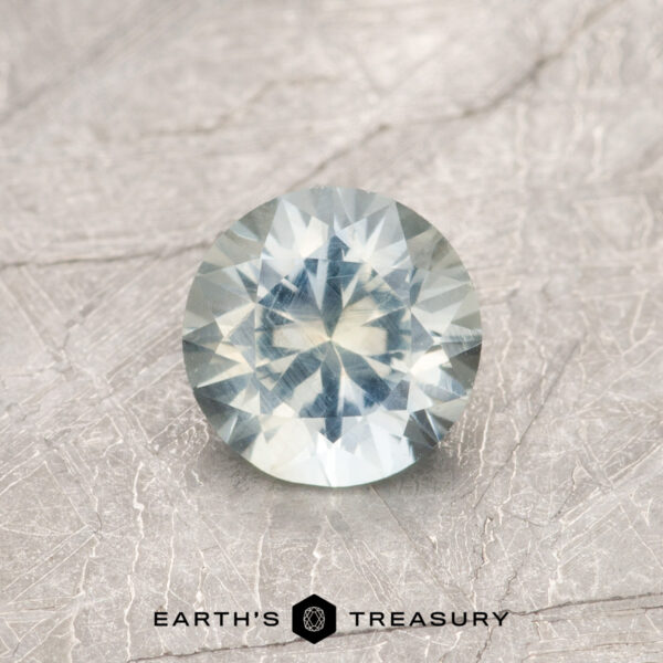 0.81-Pale Blue-Yellow Parti-colored Montana Sapphire A particolored Montana sapphire in a classic diamond round brilliant design