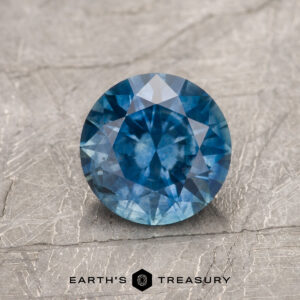 A blue Montana sapphire in a classic diamond round brilliant design