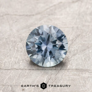 A gray Montana sapphire in a classic diamond round brilliant design