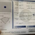 A document titled "American Gemological Laboratories" detailing the properties of a natural 1.74-Carat Rich Blue Burmese Sapphire. Includes information on weight, measurements, color, origin, and enhancement. An image of the sapphire is on the left side, with a diagram below it.