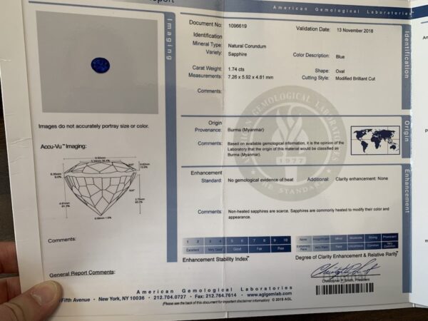 ET1639 AGL report A document titled "American Gemological Laboratories" detailing the properties of a natural 1.74-Carat Rich Blue Burmese Sapphire. Includes information on weight, measurements, color, origin, and enhancement. An image of the sapphire is on the left side, with a diagram below it.
