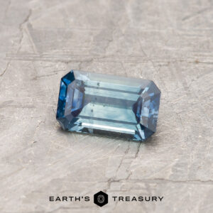 A particolored Montana sapphire in a classic emerald cut