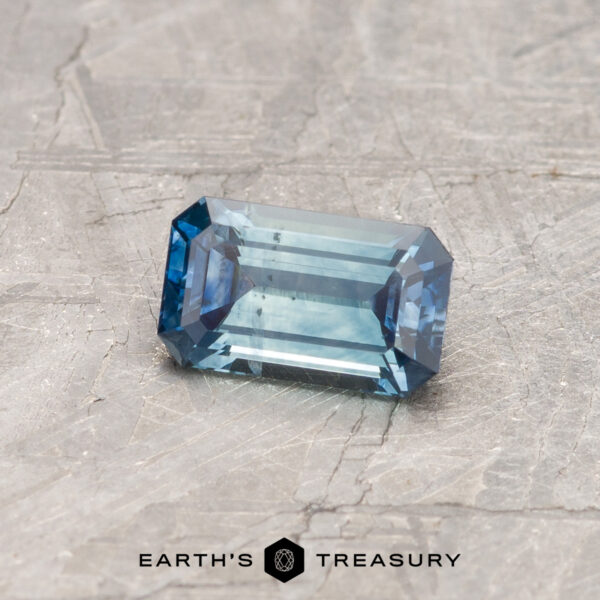 0.70 Aqua-Blue Bicolored Montana Sapphire (Heated) A particolored Montana sapphire in a classic emerald cut