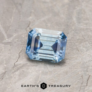 A particolored Montana sapphire in a classic emerald cut