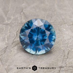 A blue Montana sapphire in a classic diamond round brilliant design