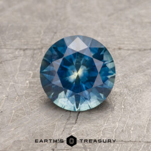 A particolored Montana sapphire in a classic diamond round brilliant design