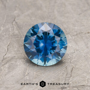 A blue Montana sapphire in a classic diamond round brilliant design