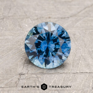A blue Montana sapphire in a classic diamond round brilliant design