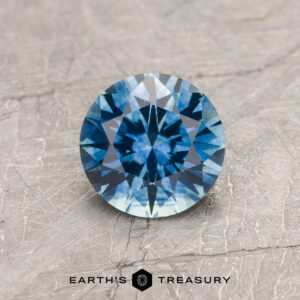 A blue Montana sapphire in a classic diamond round brilliant design