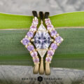 The "Melilai" ring in 14k yellow gold with a 1.06-carat Montana sapphire, paired with the "Melilai" band—both elegantly displayed on a green leaf.
