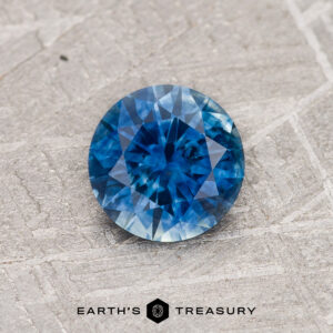 A blue Montana sapphire in a classic diamond round brilliant design