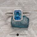 The Petite Pave Halo Ring in 14K white gold with 1.70-Carat Montana Sapphire, alongside the petite pave band in 14k white gold