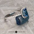 The Petite Pave Halo Ring in 14K white gold with 1.70-Carat Montana Sapphire, alongside the petite pave band in 14k white gold