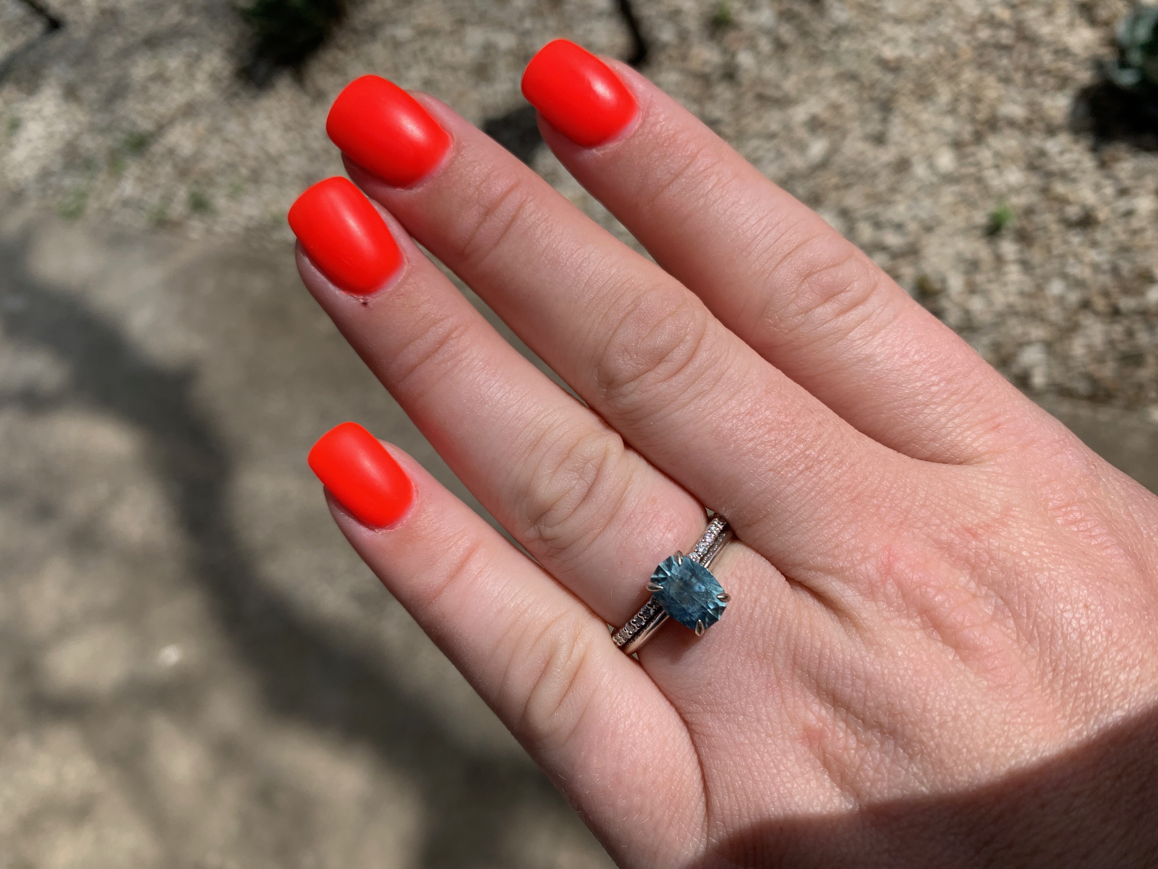 A photo from a customer review featuring a "Tiara" ring in 18k white gold with 2.85-carat Montana sapphire, alongside a"Kivu" Band in 18k white gold