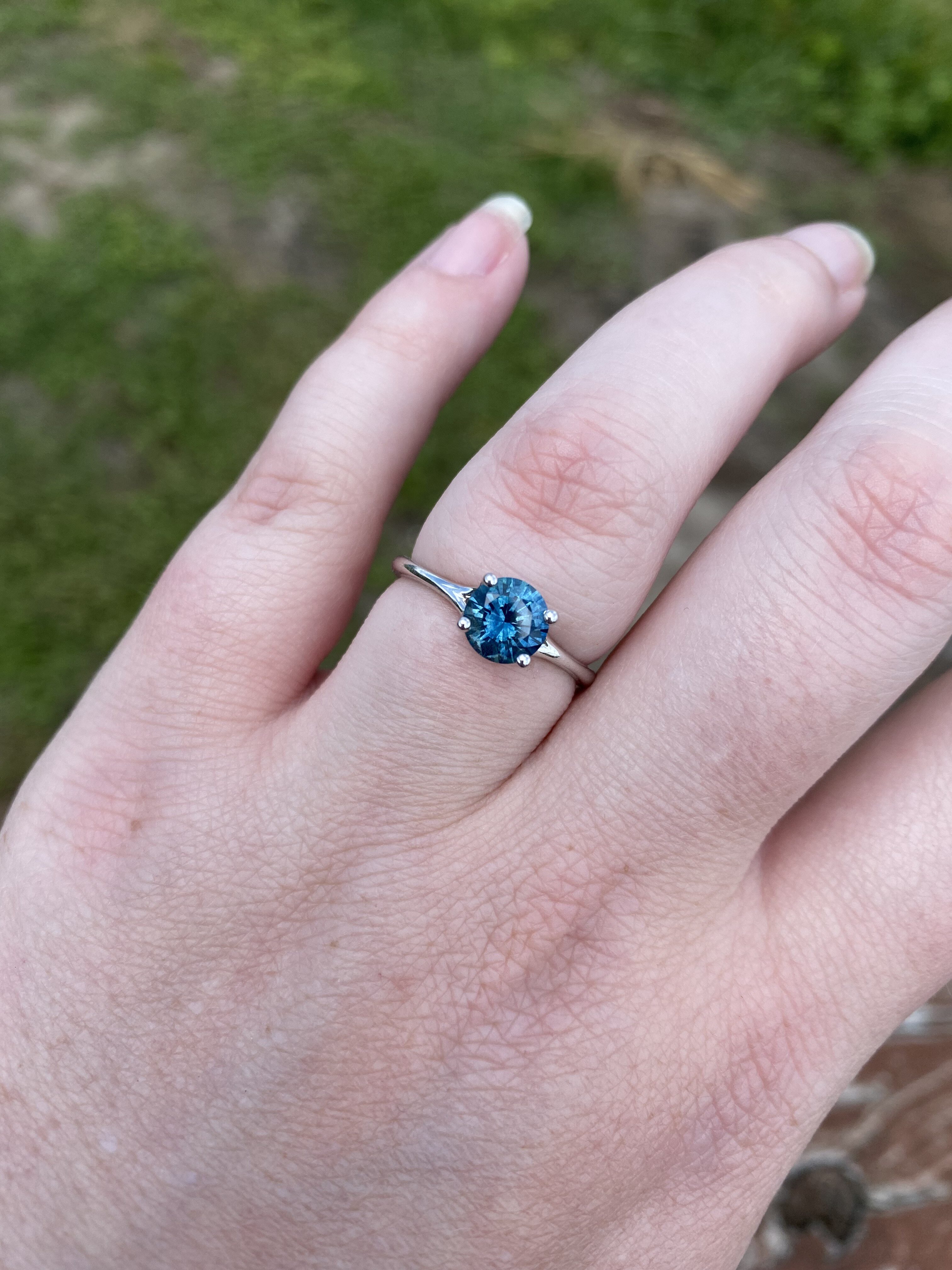 A photo from a customer review featuring a "Phoebe" ring in 14k white gold with 1.41-Carat Montana Sapphire