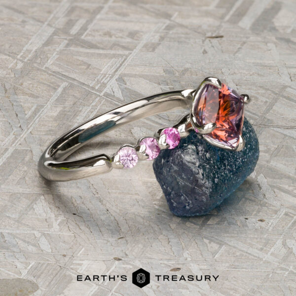 The "Dahlia" ring in platinum with 2.14-Carat Montana Sapphire The "Dahlia" ring is crafted in platinum and set with a 2.14-carat Montana sapphire, showcased on a gray textured surface.