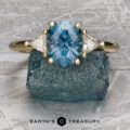 The "Stacked from 51 images. Method=B (R=1,S=1)" ring showcases an oval blue gemstone between two triangular white stones on a gold band, and is beautifully presented atop a rough blue crystal.