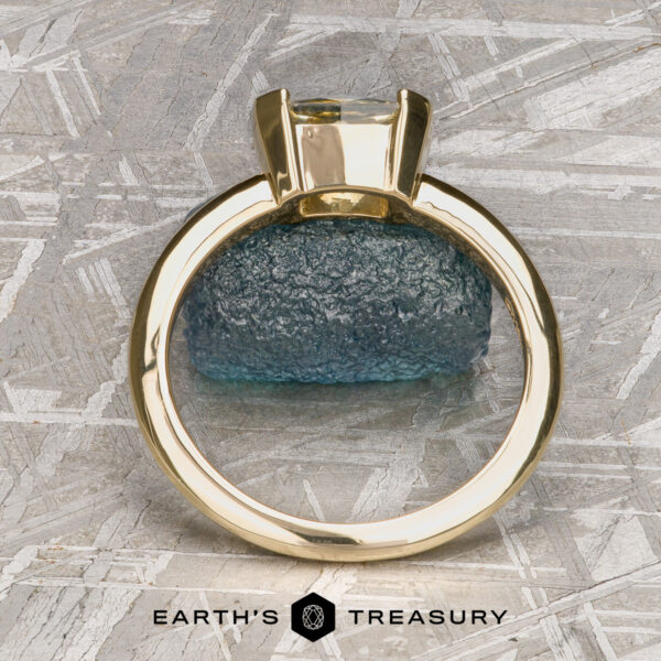 The “Larisa” ring in 18k yellow gold with 1.35-Carat Montana sapphire A gold Larisa Solitaire ring with a clear gemstone is displayed upright before a rough blue stone, labeled "Stacked from 53 images. Method=B (R=8,S=4)" below.