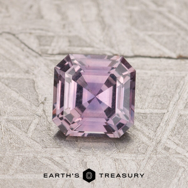 0.79-Carat Purple Montana Sapphire A 0.79-carat Purple Montana Sapphire with a square step cut is shown on a textured background, featuring the "Earth's Treasury" logo below.