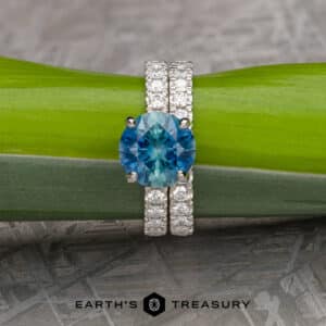A gemstone ring with pave set diamonds on the band