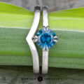 The “Capella” ring in 18k white gold, hammered and brushed, with 1.31-Carat Montana Sapphire, alongside the custom-fit contour band in 18k white gold, hammered and brushed