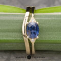 The "Niamh" ring in 14k yellow gold with 1.62-carat Umba sapphire, alongside the custom-fit contour band