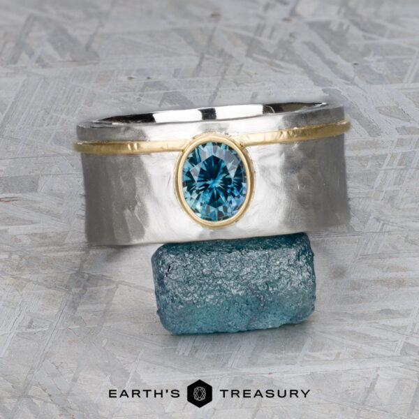 The "Armando" ring with 1.57-carat Montana sapphire The "Armando" ring with a 1.57-carat Montana sapphire, set in silver and gold, is shown balanced on a rough blue stone, with the text "EARTH'S TREASURY" below.