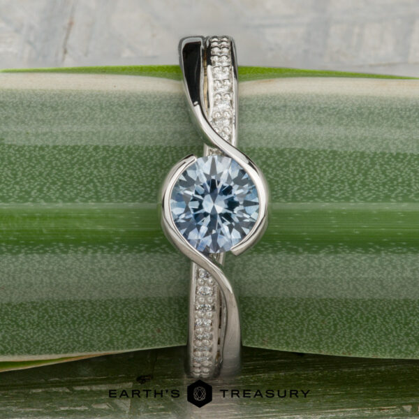 The "Faye" ring in platinum with 0.92-carat Montana sapphire The "Faye" ring in platinum features a 0.92-carat Montana sapphire as its centerpiece and is displayed vertically on a green, striped leaf.