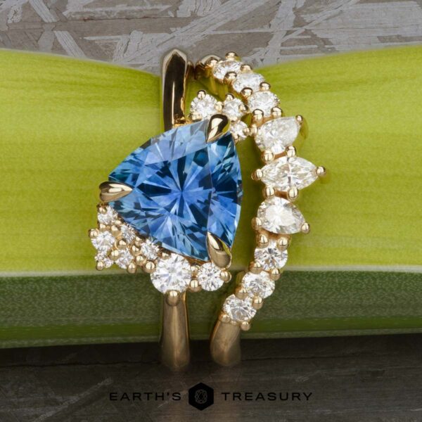The "Praesepe" ring in 14k yellow gold with 2.51-Carat Montana Sapphire, alongside the "Meuse" band in 14k yellow gold The "Praesepe" ring in 14k yellow gold with 2.51-Carat Montana Sapphire, alongside the "Meuse" band in 14k yellow gold