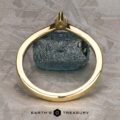 The "Laita" band in 18K yellow gold is showcased elegantly on top of a rock.