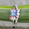 The "Ilana" ring in platinum features a 1.82-carat Benitoite, displayed on a green leaf with the Earth's Treasury logo below.