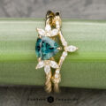 The Braided "Liriope" ring in 14k yellow gold with 1.11-carat Australian sapphire, alongside the "Cordelia" band in 14k yellow gold